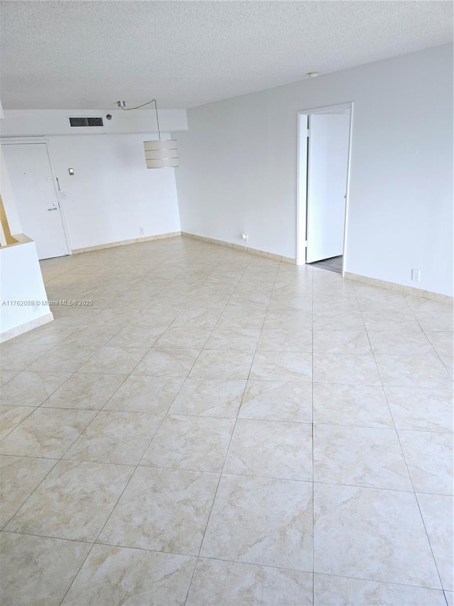 3300 NE 191st St Unit 609, Aventura, FL 33180 - spare room featuring visible vents, baseboards, and a textured ceiling