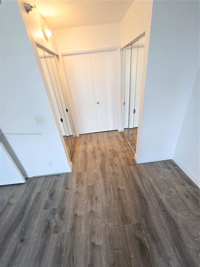 3300 NE 191st St Unit 609, Aventura, FL 33180 - interior space with baseboards, a textured ceiling, and wood finished floors