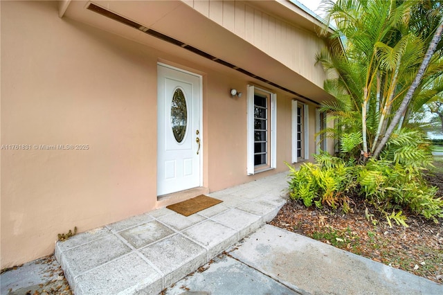 doorway to property with stucco siding