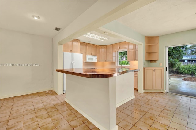 kitchen featuring white appliances, visible vents, a kitchen island, open shelves, and light tile patterned flooring