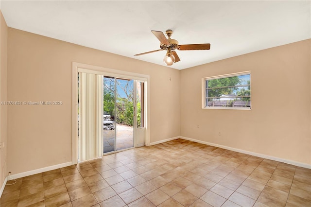 unfurnished room featuring a wealth of natural light, baseboards, ceiling fan, and light tile patterned floors