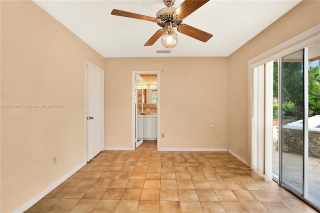 spare room with light tile patterned flooring, visible vents, ceiling fan, and baseboards