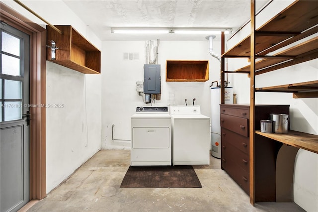 washroom with visible vents, electric panel, gas water heater, cabinet space, and washing machine and clothes dryer