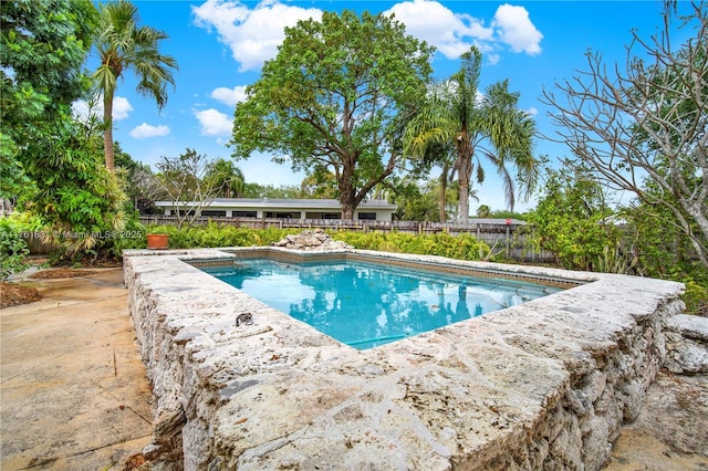 view of pool featuring a patio area, a fenced in pool, and fence