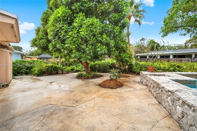 view of patio / terrace featuring fence