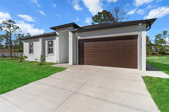 view of front facade with a front yard, an attached garage, concrete driveway, and stucco siding