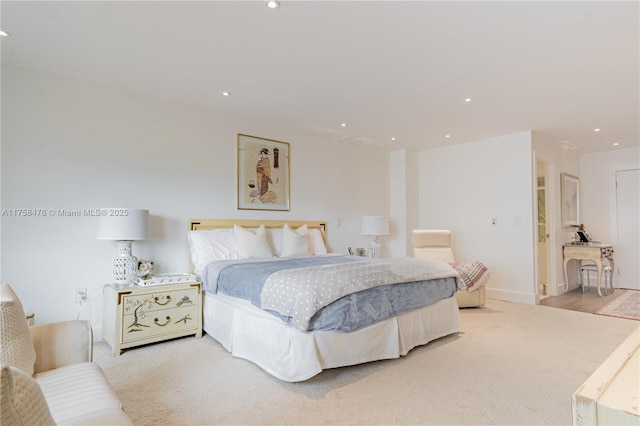 bedroom with light carpet, recessed lighting, and baseboards