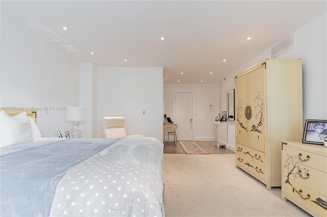 bedroom with light carpet and recessed lighting