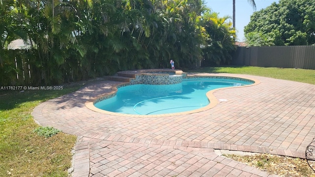 14384 SW 167th Ter, Miami, FL 33177 - view of swimming pool featuring a fenced backyard, a patio area, and a pool with connected hot tub