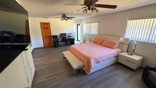 bedroom featuring ceiling fan, baseboards, a textured ceiling, and wood finished floors