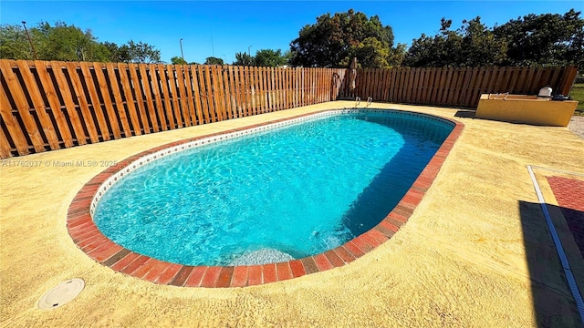 view of swimming pool with a fenced in pool, a patio, and a fenced backyard