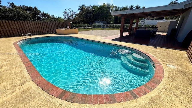 view of swimming pool with a patio area, a fenced in pool, and a fenced backyard