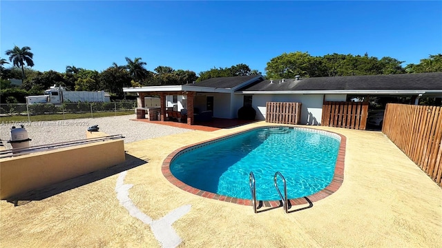 view of pool featuring a fenced in pool, a patio area, and fence