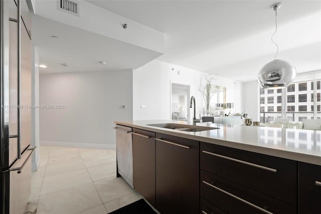 500 Brickell Ave Unit 2510, Miami, FL 33131 - kitchen featuring visible vents, a sink, stainless steel dishwasher, open floor plan, and light countertops