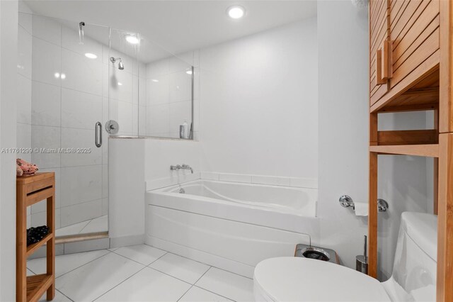 500 Brickell Ave Unit 2510, Miami, FL 33131 - full bathroom featuring a bath, tile patterned floors, a stall shower, and toilet