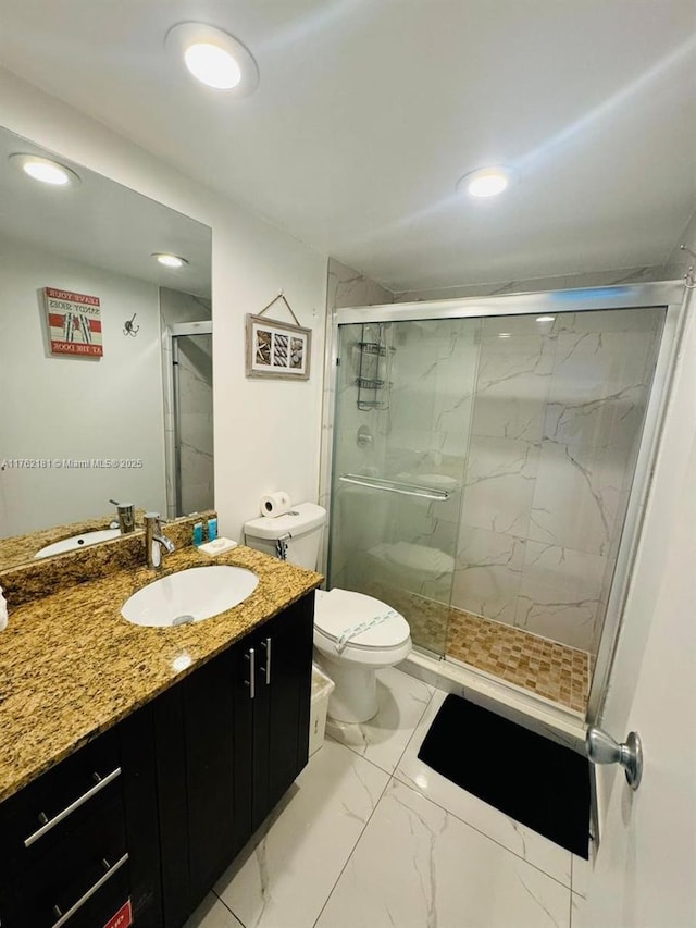 bathroom featuring vanity, a marble finish shower, recessed lighting, toilet, and marble finish floor