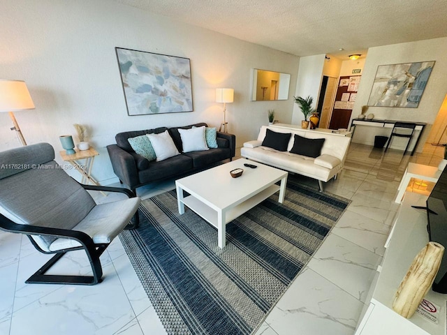 living room featuring marble finish floor and a textured ceiling