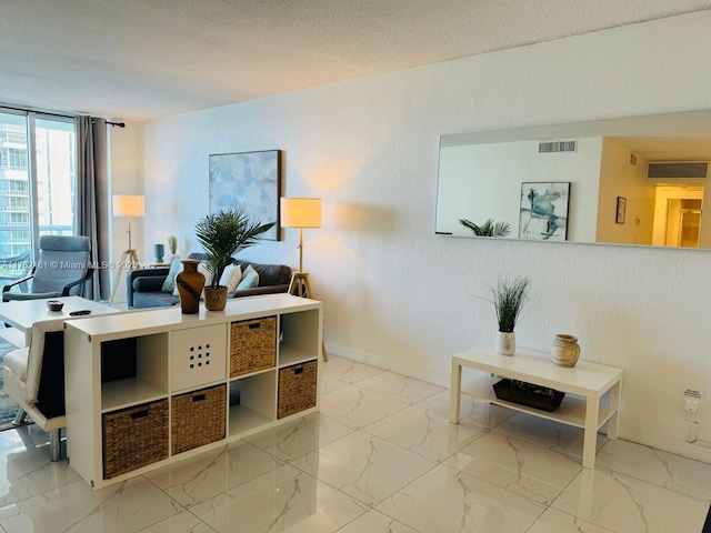 home office featuring baseboards, visible vents, a textured ceiling, a textured wall, and marble finish floor