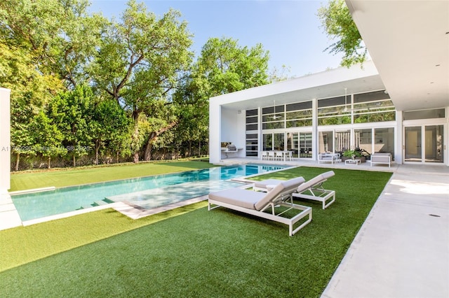 pool featuring a yard and a patio area