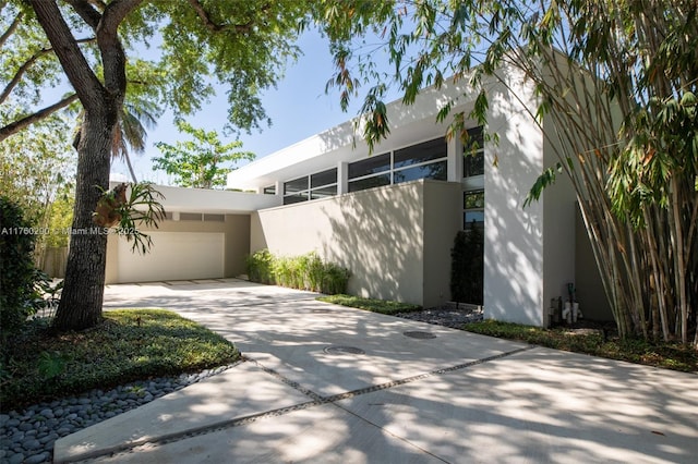 view of property exterior with driveway and stucco siding