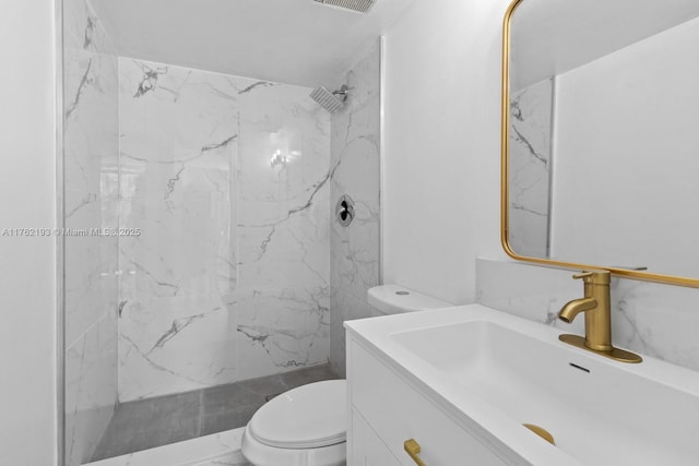 bathroom featuring a marble finish shower, toilet, visible vents, and vanity