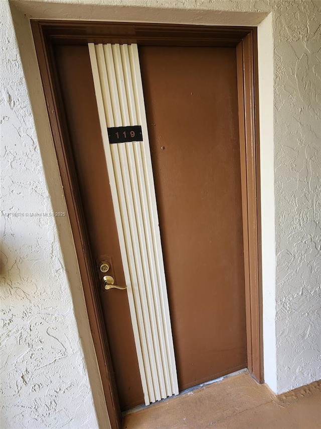 view of exterior entry with stucco siding