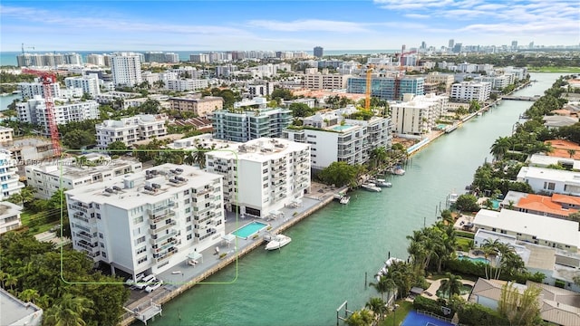 drone / aerial view featuring a view of city and a water view