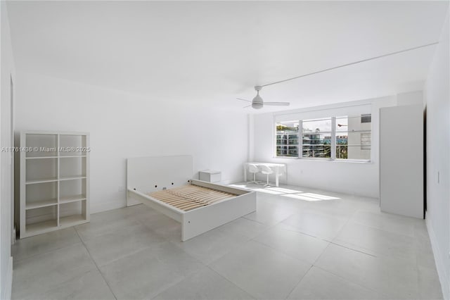 unfurnished bedroom featuring tile patterned floors and a ceiling fan