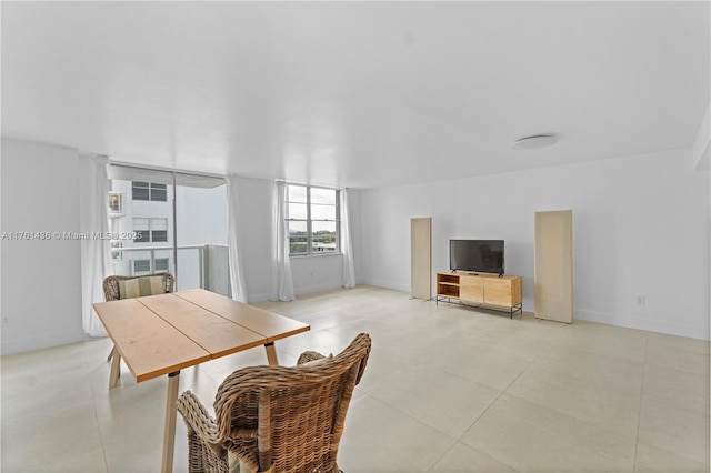 dining space with light tile patterned flooring and baseboards