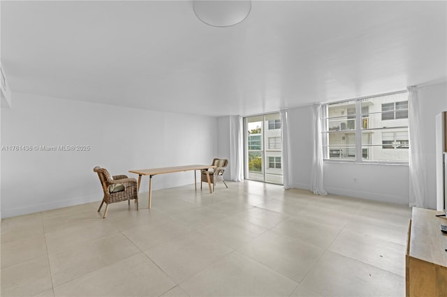 interior space with light tile patterned flooring and baseboards