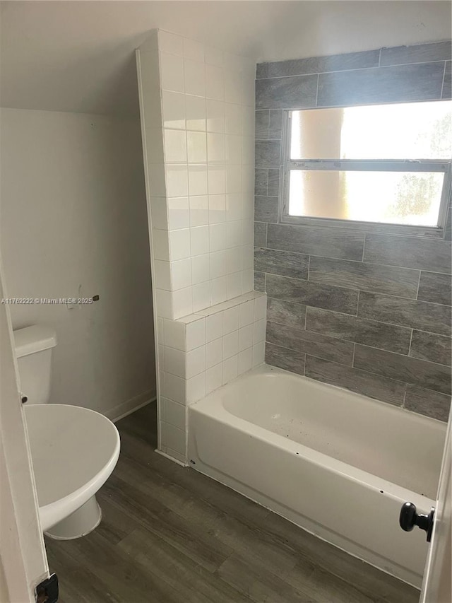 full bathroom featuring toilet, baseboards, and wood finished floors