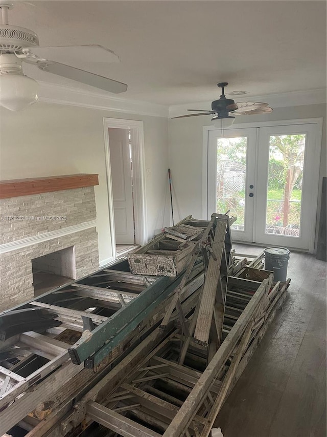 miscellaneous room featuring a fireplace, crown molding, a ceiling fan, and wood-type flooring