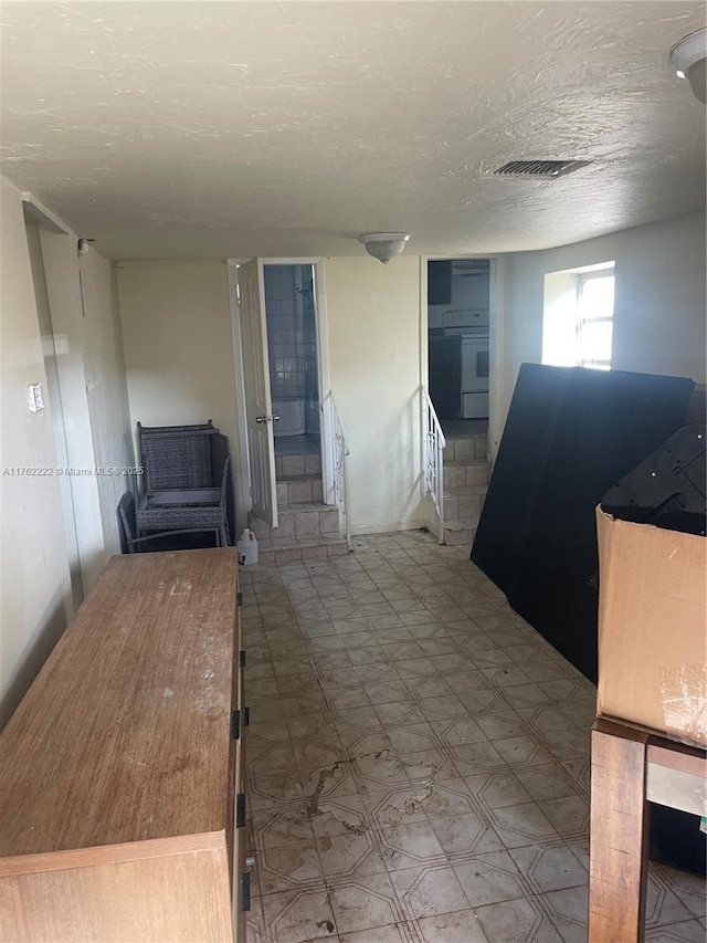 kitchen featuring tile patterned floors, visible vents, and a textured ceiling