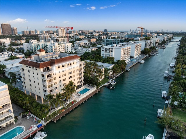 birds eye view of property with a city view and a water view