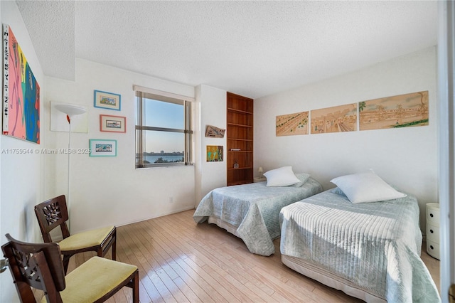 bedroom featuring a textured ceiling and hardwood / wood-style floors