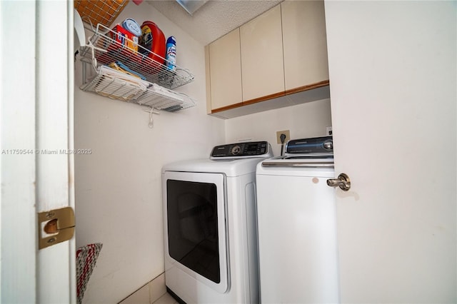 washroom with cabinet space and washing machine and dryer