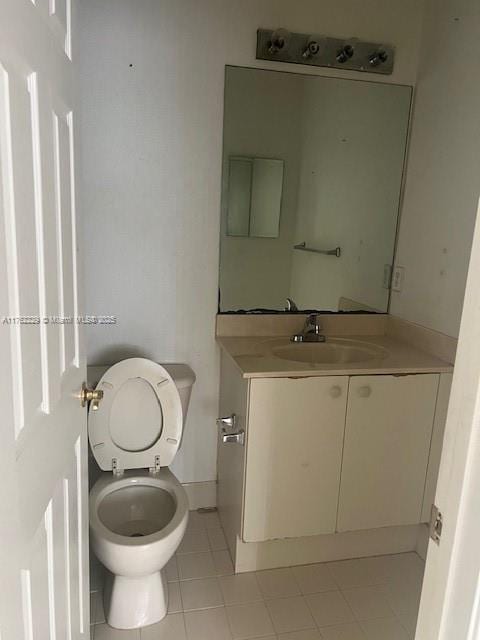 bathroom with vanity, tile patterned floors, and toilet