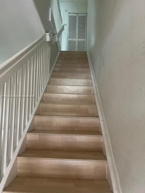 staircase with wood finished floors