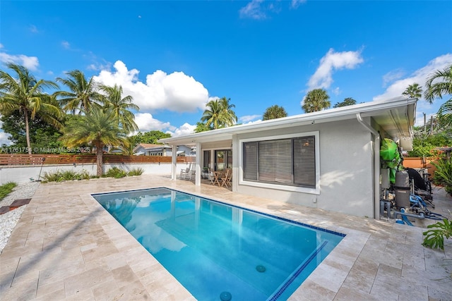 view of swimming pool featuring a fenced in pool, a patio area, and fence