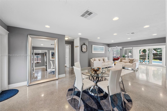 dining space with visible vents, baseboards, and speckled floor
