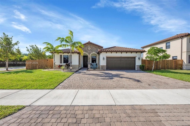 mediterranean / spanish-style home featuring decorative driveway, stone siding, an attached garage, and fence