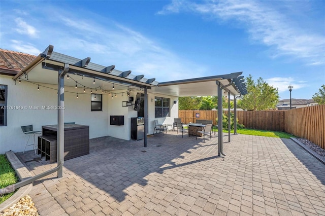 view of patio featuring a fenced backyard and a fire pit