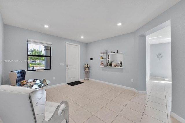 living room featuring light tile patterned floors, baseboards, and recessed lighting