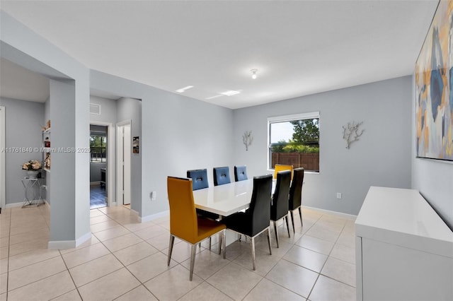 dining area featuring visible vents, baseboards, and light tile patterned flooring