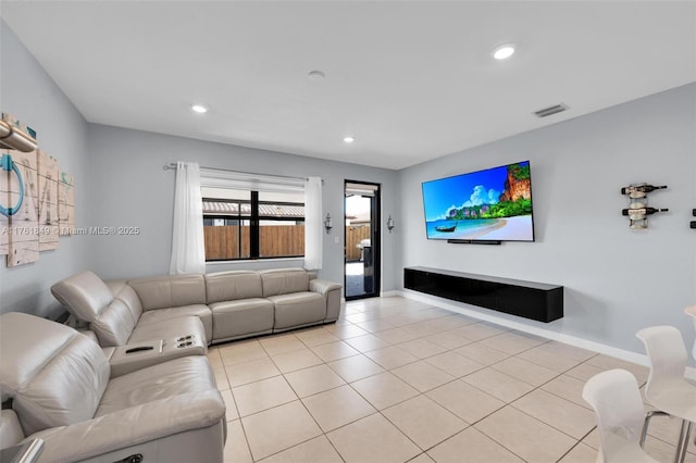 living room featuring light tile patterned flooring, visible vents, recessed lighting, and baseboards