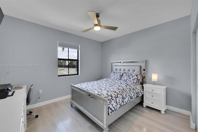 bedroom with baseboards, light wood finished floors, and ceiling fan