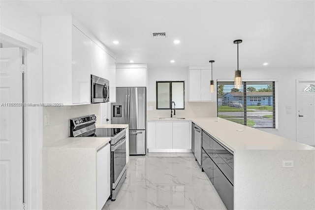 kitchen featuring visible vents, appliances with stainless steel finishes, a peninsula, marble finish floor, and modern cabinets