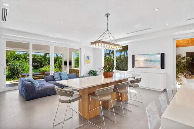 dining space featuring light tile patterned flooring and french doors