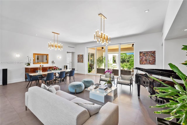 living area with tile patterned flooring, a notable chandelier, and baseboards