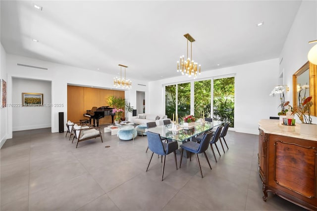 dining room with baseboards and a chandelier